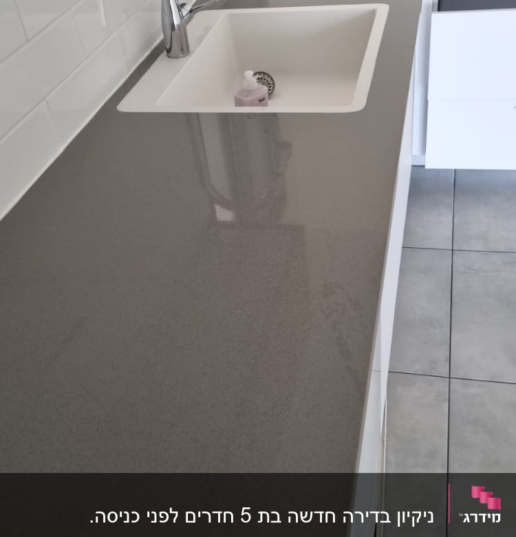 כיור מטבח עם ברז וסבון נוזלי על השיש